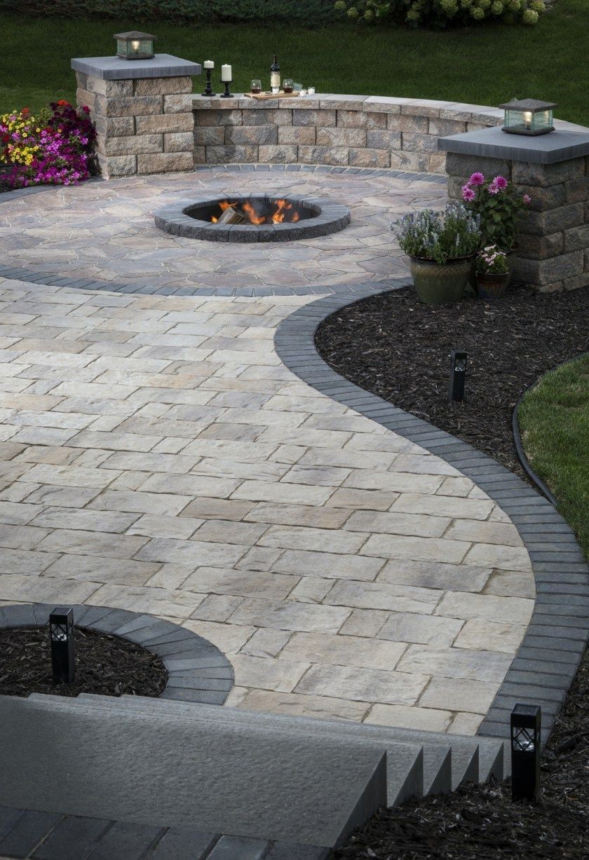 Firepit built into the ground of a patio.